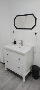 a white bathroom sink with a mirror on the wall at Templerhaus Boppard in Boppard