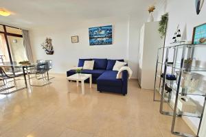 a living room with a blue couch and a table at Apartment Marina in Calpe