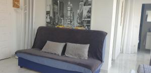 um sofá azul com duas almofadas numa sala de estar em Platja d'Aro 1 BR apartment em Platja d'Aro