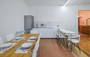 kuchnia z drewnianym stołem z białymi płytami w obiekcie Stunning Apartment In Genova With Wifi w Genui