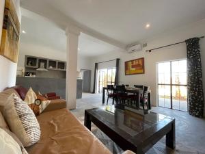 ein Wohnzimmer mit einem Sofa und einem Tisch in der Unterkunft Villa exclusive piscine privée proche centre in Marrakesch