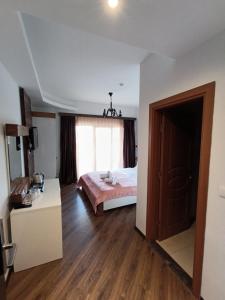 a bedroom with a bed and a large window at Hotel Happy in Gjakove