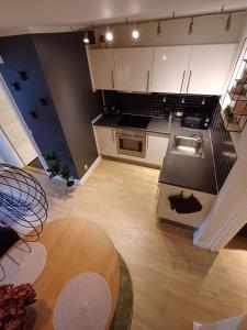 a large kitchen with white cabinets and a wooden floor at Elegant Apartment In Central Aalborg in Aalborg