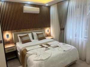 a bedroom with a large bed with towels on it at Ninova Boutique Hotel in Istanbul