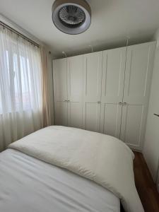 - une chambre avec un lit avec des placards blancs et une fenêtre dans l'établissement RINO, à Klis