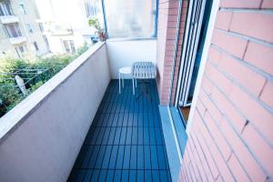 a balcony with a chair and a window at [15min to Downtown] Cozy Escape in Milan in Milan