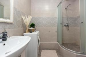 a bathroom with a sink and a shower and a tub at Sun Уш-Сункар in Almaty