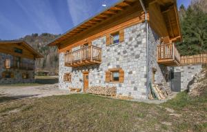 a large stone building with wooden balconies on it at Amazing Home In Castello Tesino With House A Mountain View in Castello Tesino
