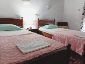 2 Betten in einem Zimmer mit 2 Betten sidx sidx sidx sidx in der Unterkunft Nikos Rooms in Loutra Edipsou