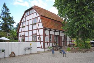 a small house with a red roof at Remise 2 in Neustadt in Holstein