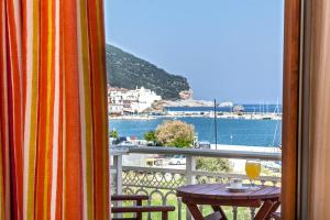 a balcony with a table and a view of the water at MON REPOS in Panormos Skopelos