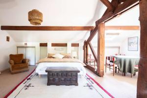 a bedroom with a bed and a table and chairs at Réf 143 Seignosse Estagnots, Villa" Assouinde" classée 4 étoiles avec Wifi pour 9 personnes au calme à proximité de la plage in Seignosse