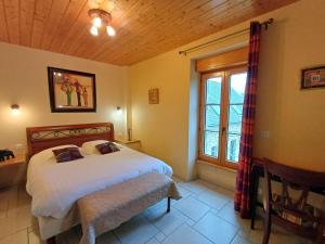a bedroom with a large bed and a window at Gite de Kerantum in Mahalon