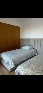 A bed or beds in a room at Golf prestigia marrakech rez de jardin