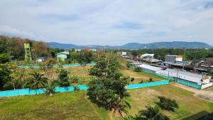 an aerial view of a small village with trees and buildings at Plus condominium 2 kathu in Ban Thung Thong