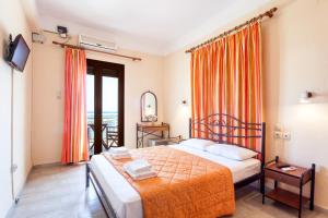 a hotel room with a bed and a balcony at MON REPOS in Panormos Skopelos