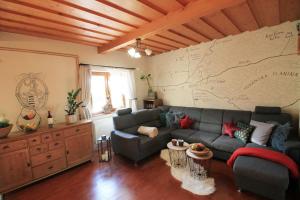 a living room with a couch and a map on the wall at Eden guest house in Brezno