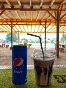 a drink sitting next to a pepsi cup on a table at Hotel Markovi Kuli TD in Prilep