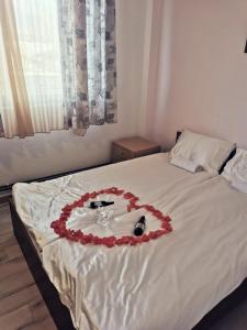 a bed with a heart made out of roses at Hotel Markovi Kuli TD in Prilep