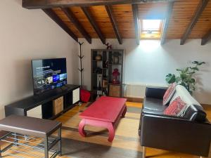 a living room with a couch and a red coffee table at BILBO Near ático rural con terraza in Basauri