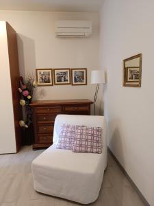 a room with a bed and a table with pictures on the wall at La Casetta - Near the sea & free parking in Rapallo