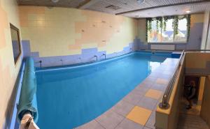a large swimming pool in a building at Pokoje Cichy Kącik in Zakopane