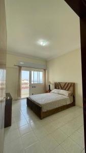 a bedroom with a bed and a large window at Elegant and Panoramic 3-Bedroom in Central Tangier in Tangier