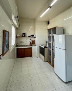 a kitchen with a white refrigerator and a stove at Elegant and Panoramic 3-Bedroom in Central Tangier in Tangier