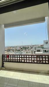 a large window in a building with a view of a city at Elegant and Panoramic 3-Bedroom in Central Tangier in Tangier