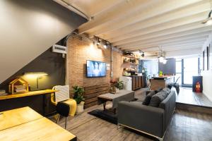a living room with a couch and a table at 2BR House with Bathtub near Old City in Chiang Mai
