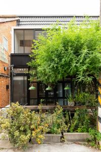 a building with a bunch of plants in front of it at 2BR House with Bathtub near Old City in Chiang Mai