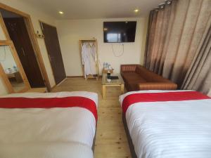 Letto o letti in una camera di Hotel Odaan