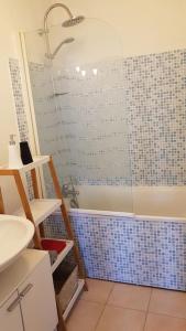 a bathroom with a shower and a sink at Au coeur de Dieppe, au puits salé BY HOLIDIEPPE in Dieppe +14 photos