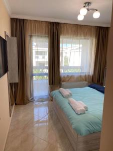 a bedroom with a bed with two pillows and a window at Luxury Sea Villa - Kabalan 1 in Burgas City