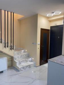 a bathroom with marble stairs and a black door at Luxury Sea Villa - Kabalan 1 in Burgas City