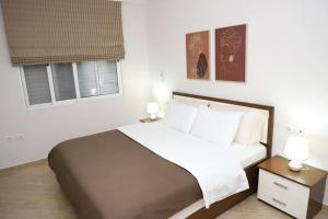 Ένα ή περισσότερα κρεβάτια σε δωμάτιο στο Angelo Apartment