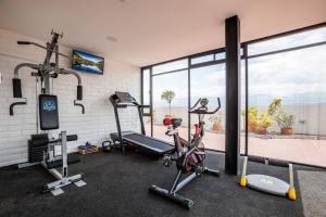 a gym with two treadmills and two exercise bikes at Mumbai Penthouse Studio in Quito