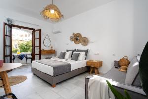 a bedroom with a bed and a couch at Katerina Studios in Naxos Chora