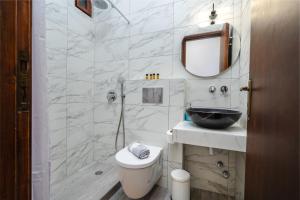 a bathroom with a toilet and a sink and a mirror at Katerina Studios in Naxos Chora +44 photos