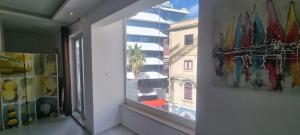 a window in a room with paintings on the wall at VBH APARTMENT PACEVILLE ST. JULIAN'S in Paceville