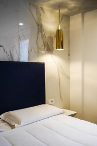 a bedroom with a bed with a black headboard at Hotel La Rocca in Nogarole Rocca