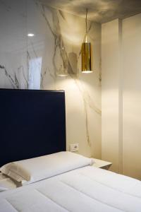 a bedroom with a bed with a black headboard at Hotel La Rocca in Nogarole Rocca +20 photos