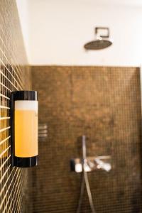 a cup hanging on a wall in a bathroom at Hotel La Rocca in Nogarole Rocca