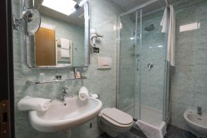 a bathroom with a sink and a shower and a toilet at Hotel Iris in Genoa