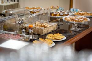 a buffet with various pastries and pastries on a table at Hotel Iris in Genoa
