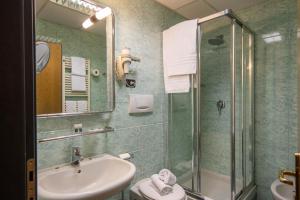 a bathroom with a sink and a shower at Hotel Iris in Genoa
