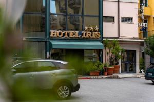a green car parked in front of a hotel hits at Hotel Iris in Genoa