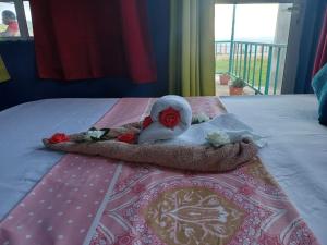 um bicho de peluche está deitado numa cama em Chez Tonio Magic Ocean View em Rodrigues Island