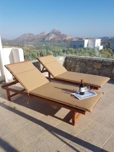 a couple of beds sitting on a patio at Villa Jazmin in Marioú