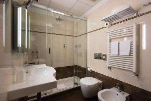 a bathroom with a sink and a toilet and a shower at Hotel Iris in Genoa
